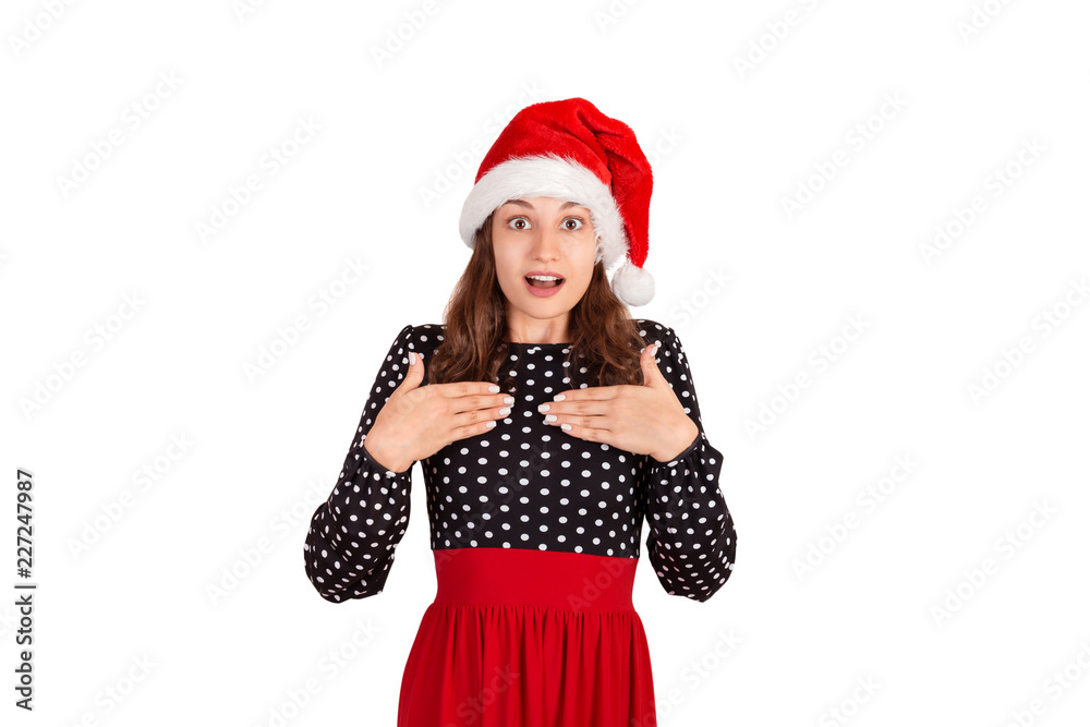 surprised woman in dress holding hands on breast smiling being touched and pleased. emotional girl in santa claus christmas hat isolated on white background. holiday concept surprised woman in dress holding hands on breast smiling being touched and pleased. emotional girl in santa claus christmas hat isolated on white background. holiday concept