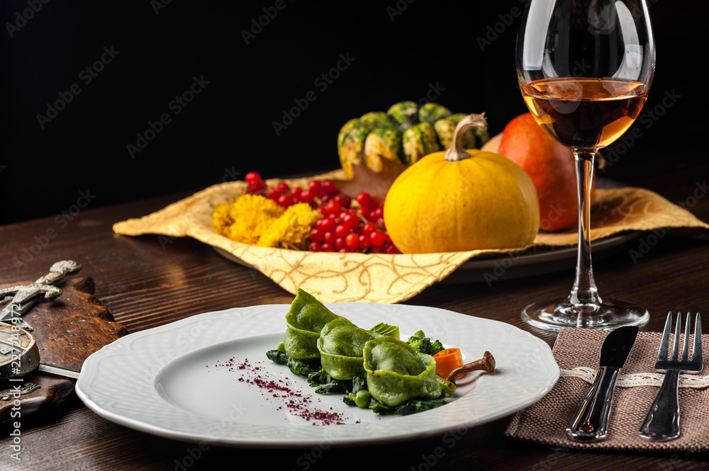 Green Ravioli with quail egg on a black background. A Halloween Feast. Green Ravioli with quail egg on a black background. A Halloween Feast.