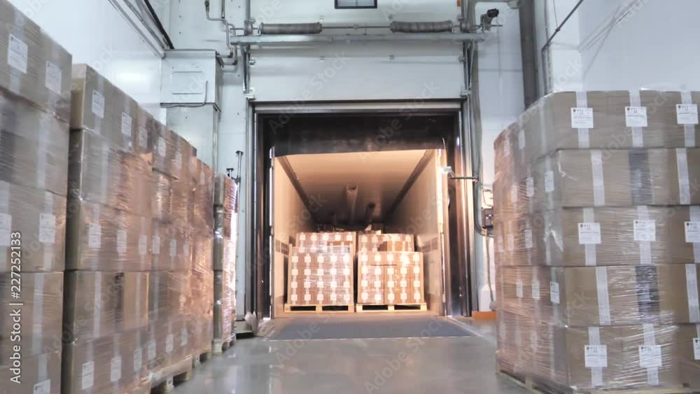Warehouse large logistics commerce structure, camera moving from dock to truck