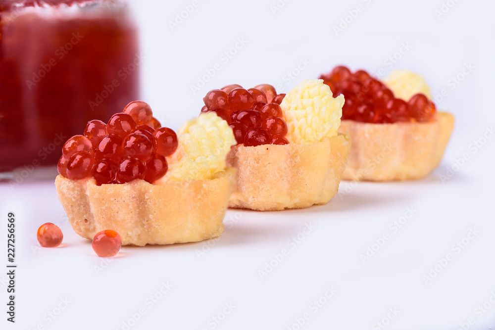 Tartlets with red caviar close up. Delicatessen. Gourmet food. Tartlets with red caviar close up. Delicatessen. Gourmet food.