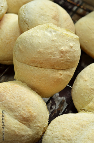 Freshly baked dinner rolls on wooden background