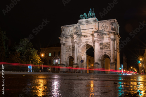 Fototapeta Naklejka Na Ścianę i Meble -  The Siegestor Victory Arch in Munich. Triumphal arch at night on a rainy day. Side view.