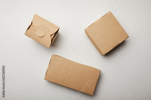 top view of wok box and food delivery boxes on white surface
