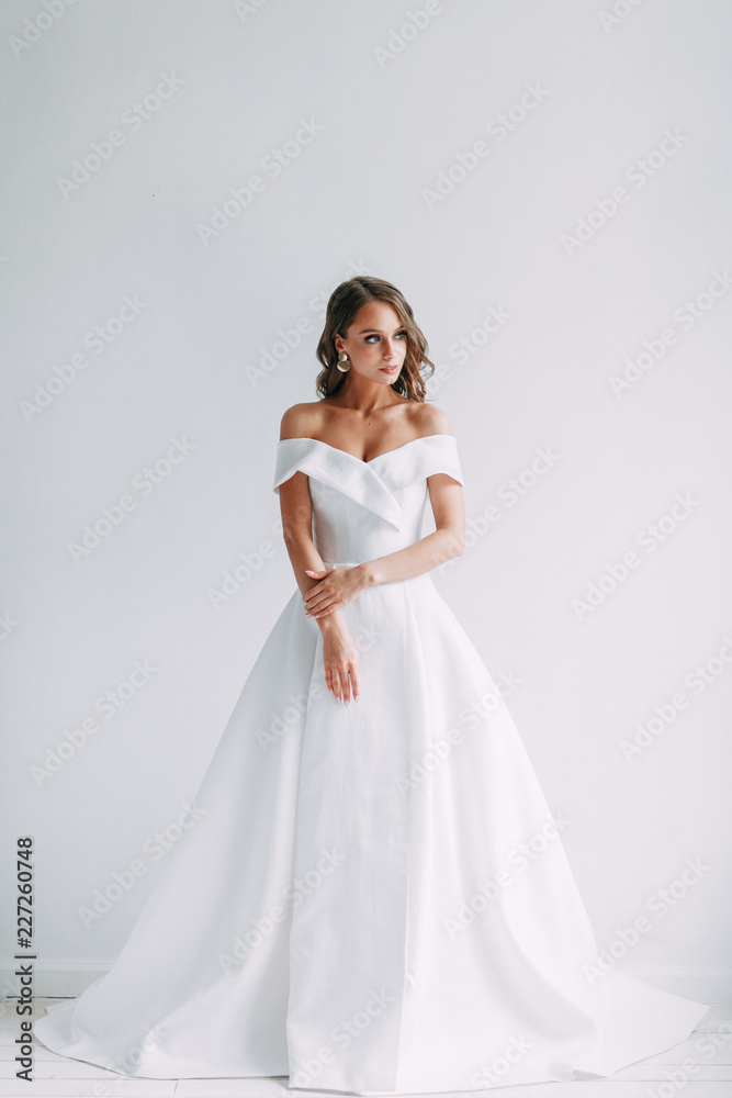 A concept wedding, contemporary European bride. Bouquet of flowers, fees in the interior Studio. Ideas for a minimalist wedding, white color A concept wedding, contemporary European bride. Bouquet of flowers, fees in the interior Studio. Ideas for a minimalist wedding, white color