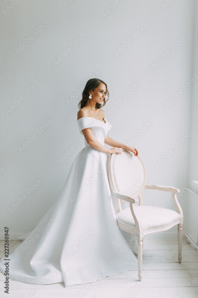 A concept wedding, contemporary European bride. Bouquet of flowers, fees in the interior Studio. Ideas for a minimalist wedding, white color A concept wedding, contemporary European bride. Bouquet of flowers, fees in the interior Studio. Ideas for a minimalist wedding, white color