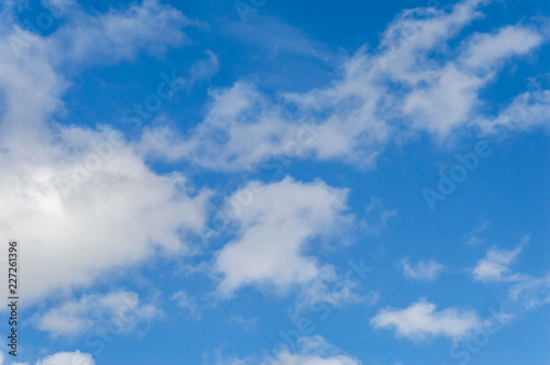 Fototapeta Naklejka Na Ścianę i Meble -  A deep blue sky with scattered clouds