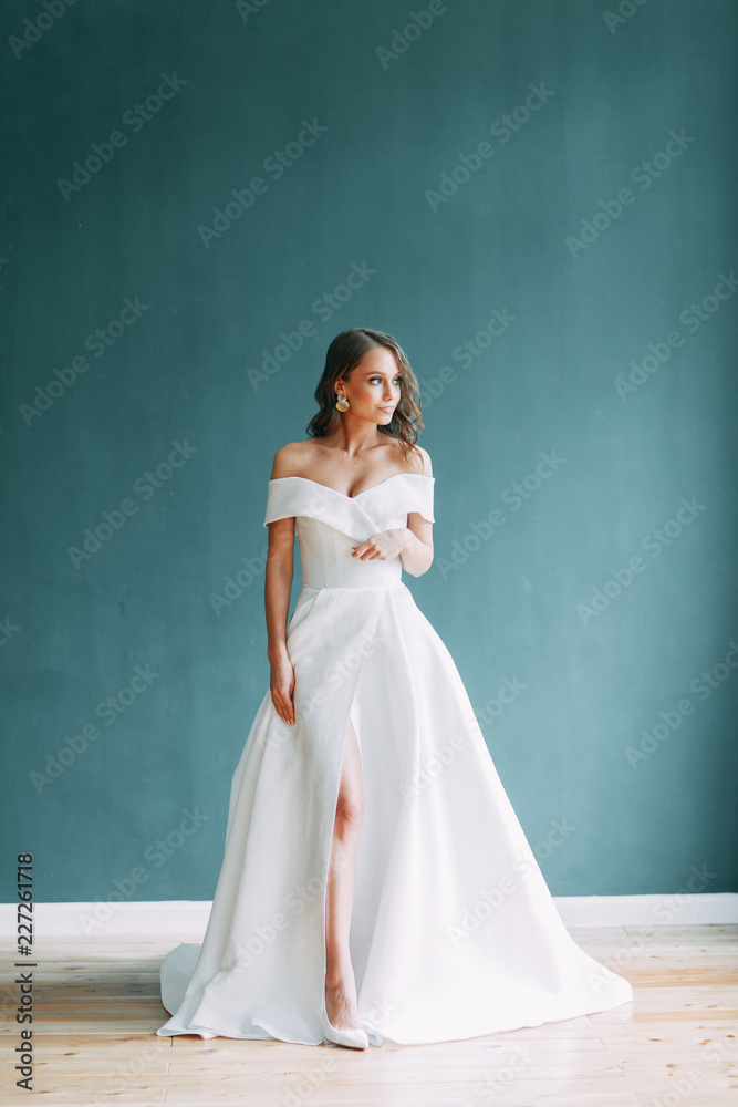 A concept wedding, contemporary European bride. Bouquet of flowers, fees in the interior Studio. Ideas for a minimalist wedding, white color A concept wedding, contemporary European bride. Bouquet of flowers, fees in the interior Studio. Ideas for a minimalist wedding, white color