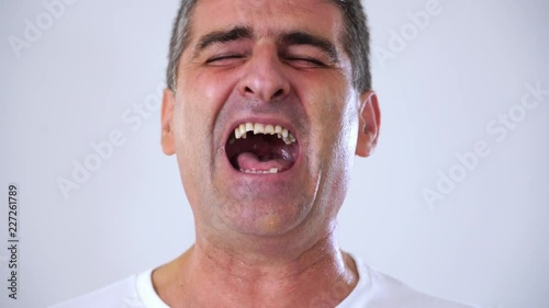 happy excited laughing facial emotion expression of middle aged man 50s 60s year old man in studio on grey background in face expression concept. 