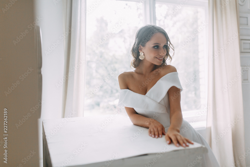 A concept wedding, contemporary European bride. Bouquet of flowers, fees in the interior Studio. Ideas for a minimalist wedding, white color A concept wedding, contemporary European bride. Bouquet of flowers, fees in the interior Studio. Ideas for a minimalist wedding, white color