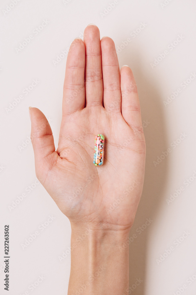 cropped shot of woman holding medical capsule on white cropped shot of woman holding medical capsule on white