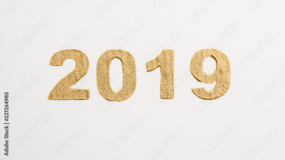 top view of 2019 year sign made of golden glitters isolated on white top view of 2019 year sign made of golden glitters isolated on white