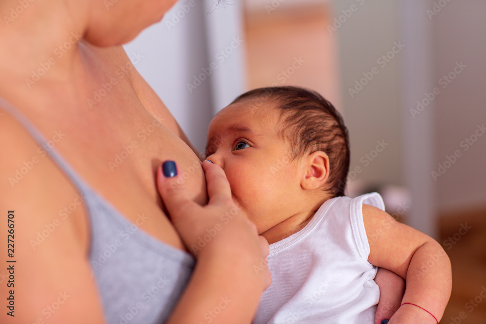 Breastfeeding - Young mother breastfeeding the newborn baby. Breastfeeding - Young mother breastfeeding the newborn baby.
