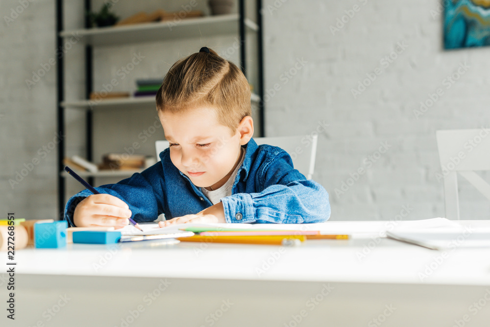cute little child drawing with color pencils at home cute little child drawing with color pencils at home