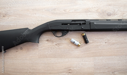 Canvas Print semi-automatic black hunting shotgun and cartridges 12 gauge, close-up view