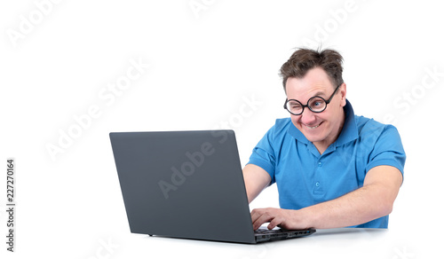Man with glasses working on a laptop at the table, isolated on white background