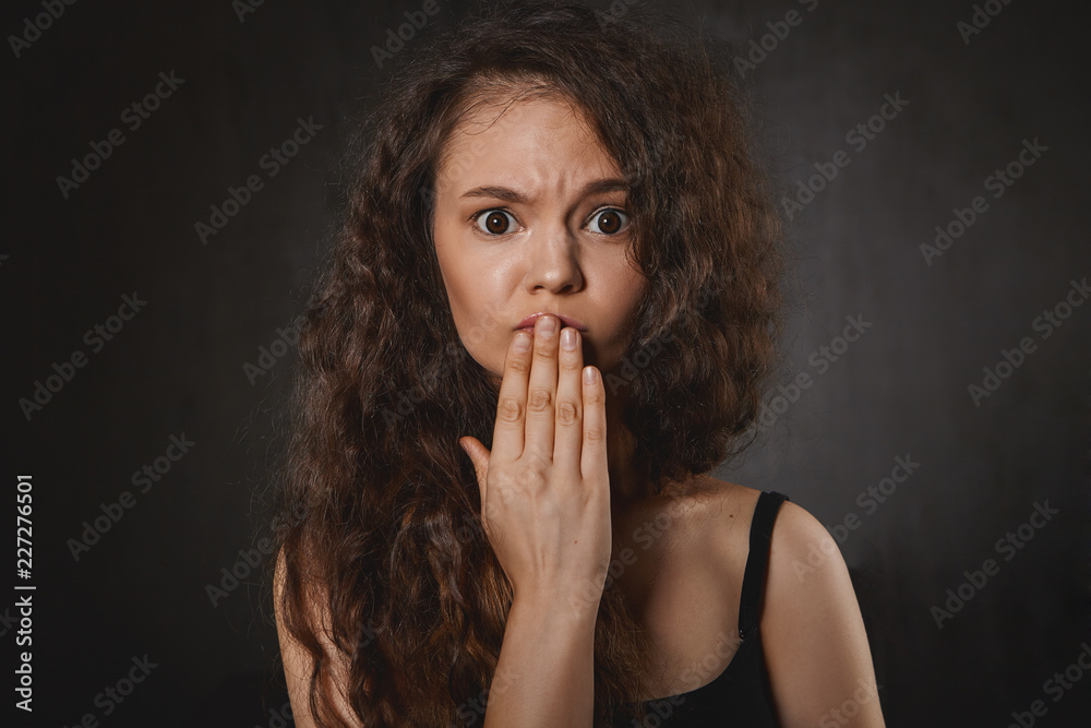 Oops. I didn't mean to hurt your feelings. Studio shot of frowning young brunette female having apologetic frustrated facial expression, covering mouth after she said something offensive to friend Oops. I didn't mean to hurt your feelings. Studio shot of frowning young brunette female having apologetic frustrated facial expression, covering mouth after she said something offensive to friend