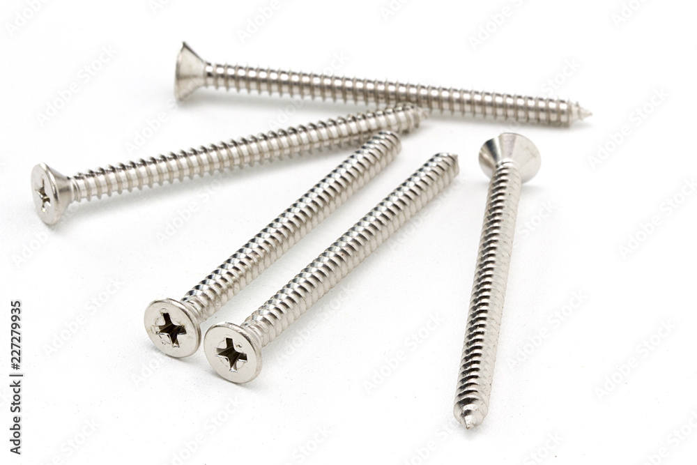 Close-up on screws, metal screws, iron screws, wood screws isolated on white background