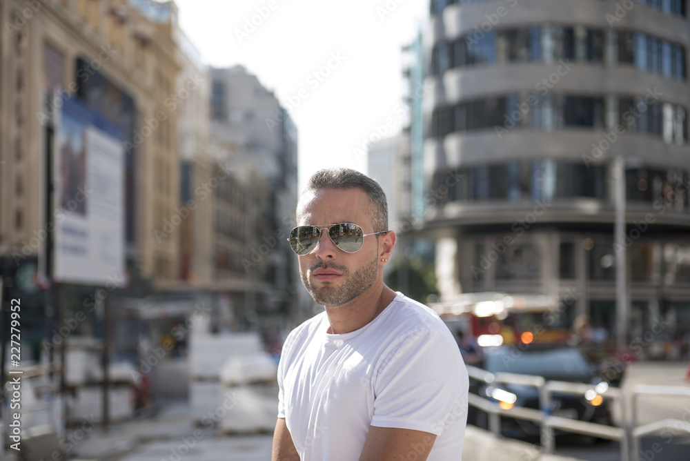 Handsome man posing in the center of the city Handsome man posing in the center of the city