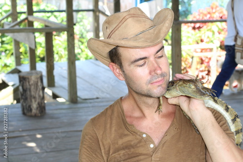 Man holding baby reptile with copy space