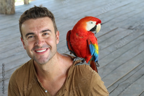 Handsome man and colourful macaw