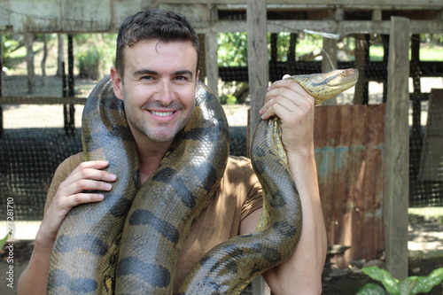 Man with a giant Anaconda around his neck