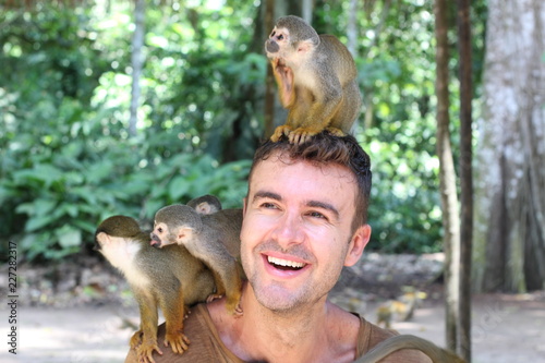 Man training a group of monkeys photo