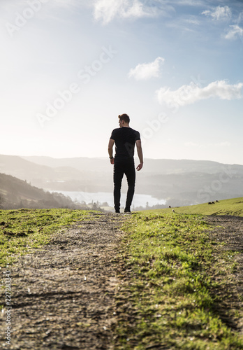 Strong Man walks out Towards an Epic Valley