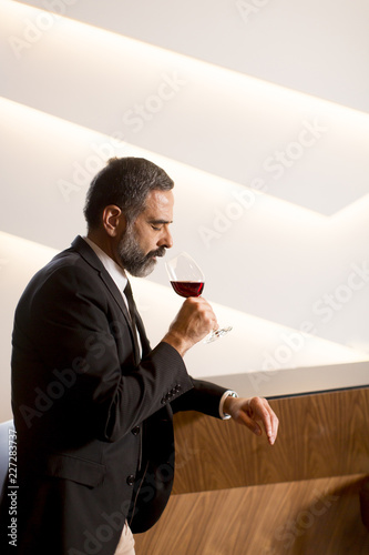 Handsome mature man tasting...