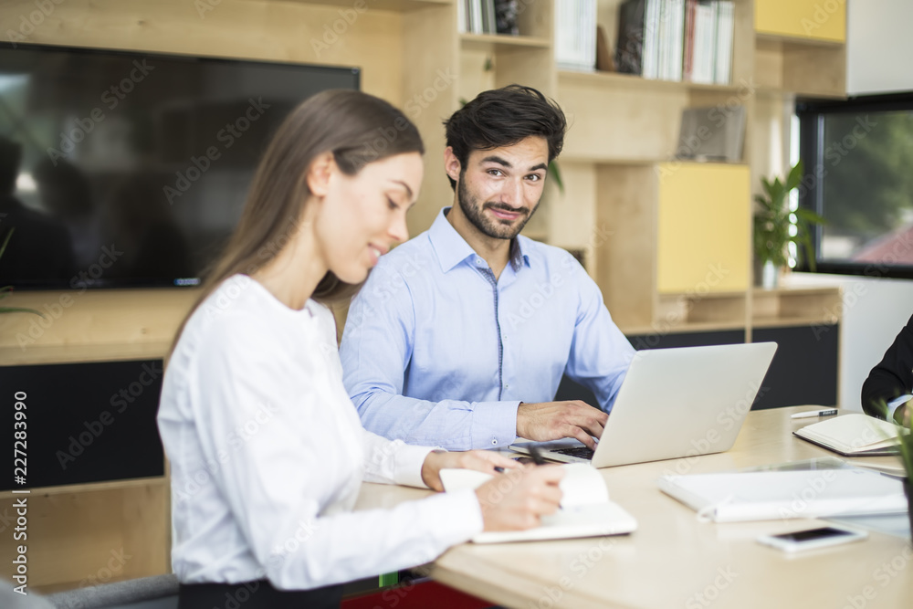 Two business people discussing new project in modern office Two business people discussing new project in modern office