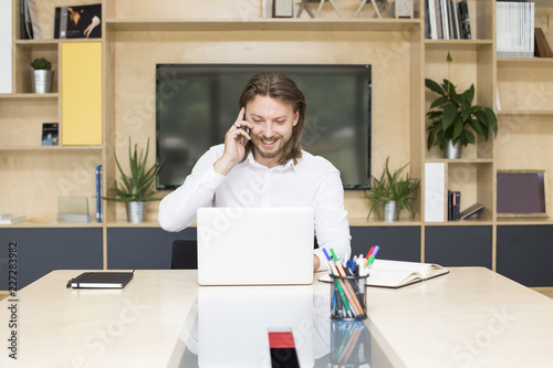 Young businessman sitting b...