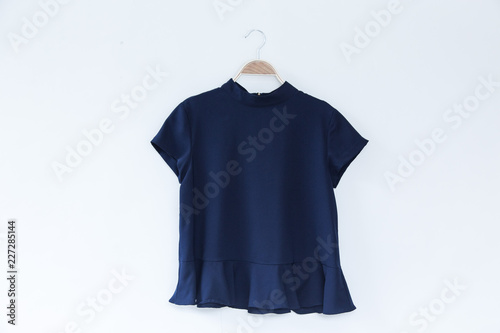 Natural colour blue clothes is clothes hanger on white background.