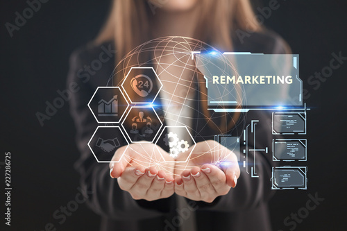The concept of business, technology, the Internet and the network. A young entrepreneur working on a virtual screen of the future and sees the inscription: Remarketing