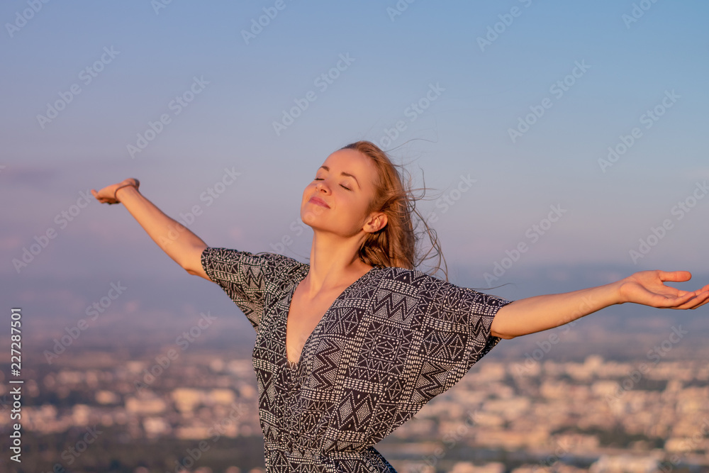 Christian worship and praise. A young woman with her hands raised in worship and praise to god. Christian worship and praise. A young woman with her hands raised in worship and praise to god.