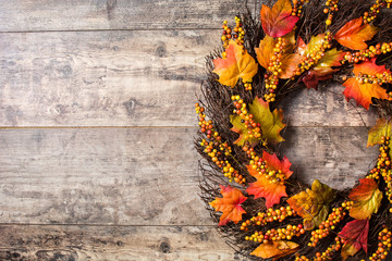 Autumn wreath on wooden background. Thanksgiving concept. Copyspace

