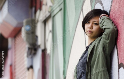 Japanese Girl poses on the street in Machida, Japan. Machida is an area located in Tokyo. photo