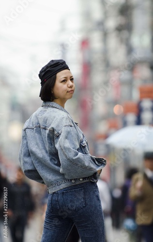 Japanese Girl poses on the street in Machida, Japan. Machida is an area located in Tokyo. photo