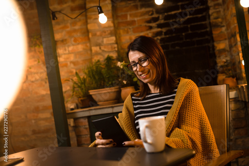 Woman using tablet. evening scene. © cherryandbees