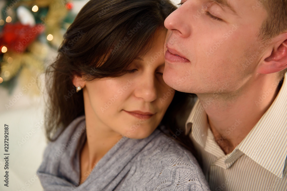 Beautiful couple in love on a Christmas, having a rest on Christmas holidays Beautiful couple in love on a Christmas, having a rest on Christmas holidays