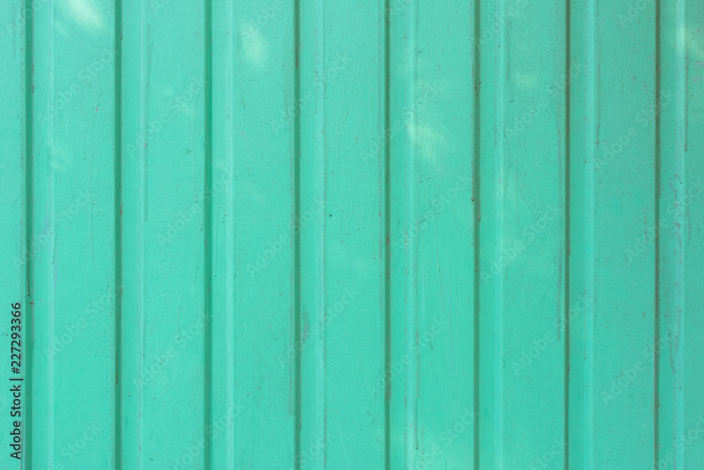 Background of smooth boards painted with light turquoise paint. Texture with stains and paint stains. Background of smooth boards painted with light turquoise paint. Texture with stains and paint stains.