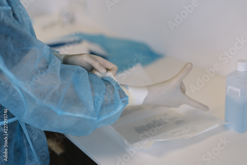 Surgeon putting on gloves before a close-up operation