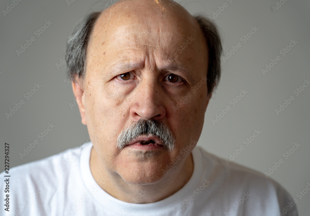 Portrait of disorientated and confused old man suffering from Alzheimer Portrait of disorientated and confused old man suffering from Alzheimer