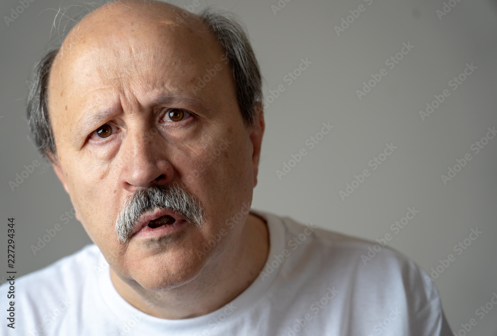 Portrait of disorientated and confused old man suffering from Alzheimer