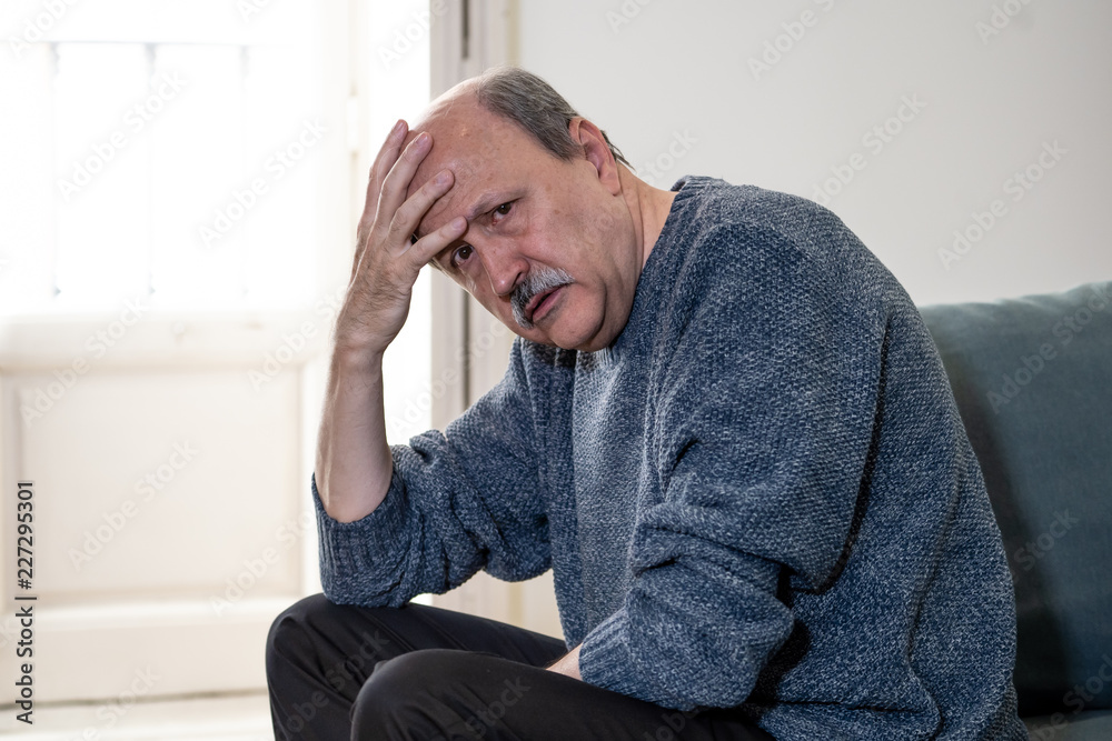 Depressed overwhelmed old man feeling exhausted alone and unhappy suffering from depression Depressed overwhelmed old man feeling exhausted alone and unhappy suffering from depression