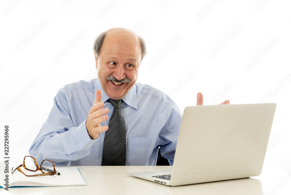 Pleased mature business man in his 60s working on laptop confident of success Pleased mature business man in his 60s working on laptop confident of success