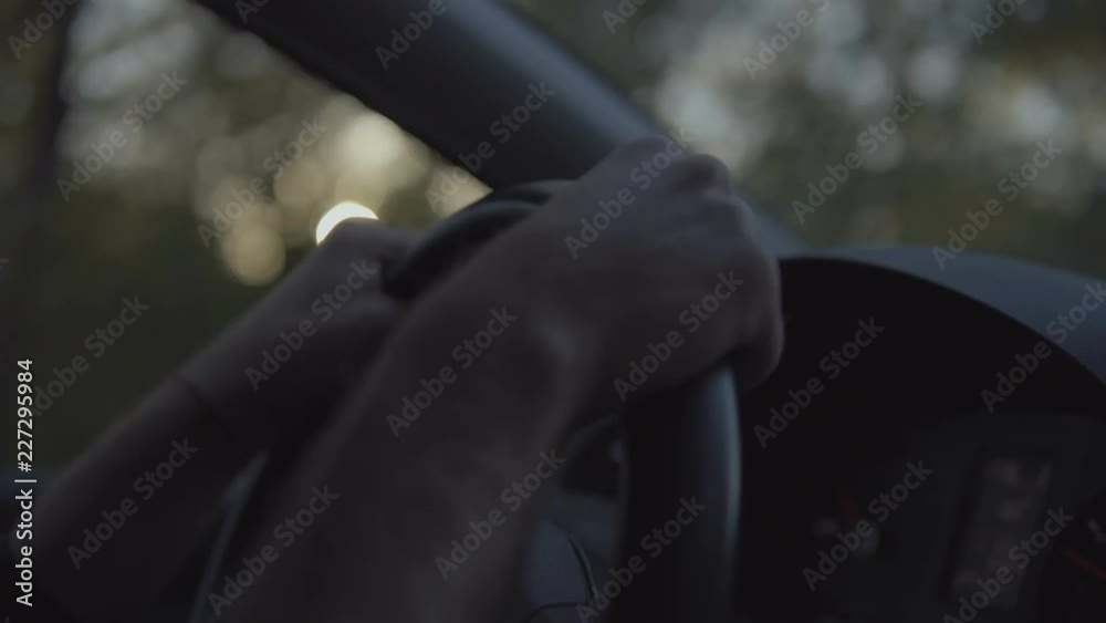 Close up Of Driver's Hands On Steering Wheel at sunset drive. Close up Of Driver's Hands On Steering Wheel at sunset drive.