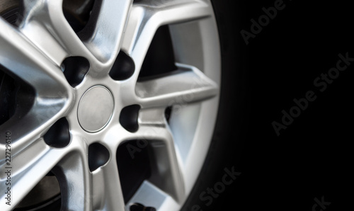 closeup alloy car wheels with soft-focus and over light in the background