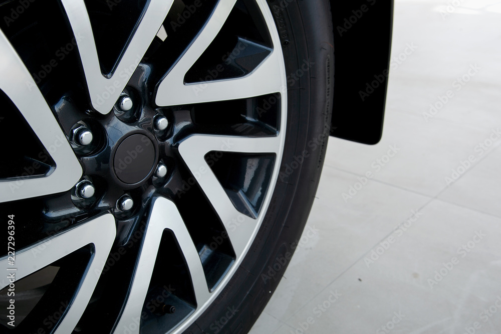 closeup alloy car wheels with soft-focus and over light in the background closeup alloy car wheels with soft-focus and over light in the background