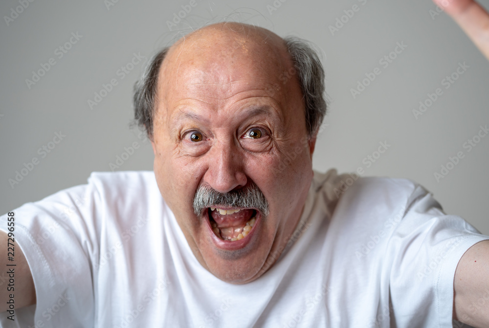 Close up portrait of surprised and happy senior man celebrating victory and wining lottery Close up portrait of surprised and happy senior man celebrating victory and wining lottery