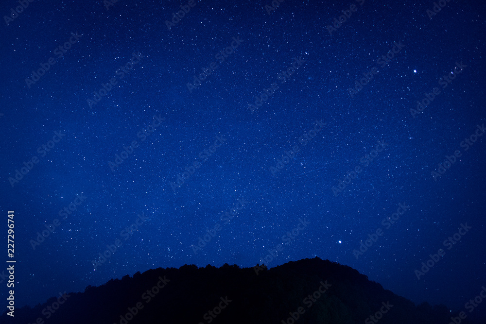 Millions of stars shine in the darkness sky in beautiful nature background.