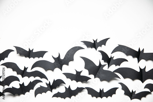 Halloween paper bat decorations on a white background. © ink drop